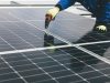 UK Solar Panels Hit Record 15,420 Megawatts Solar panels on a rooftop under a bright blue sky, generating electricity on a sunny afternoon.