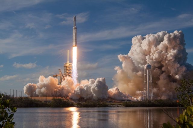 SpaceX Raptor Engine and Reusability Central to Starship's Eleven-Launch Goal Starship Super Heavy booster fires methane-oxygen Raptors during vertical touchdown beside the launch tower.